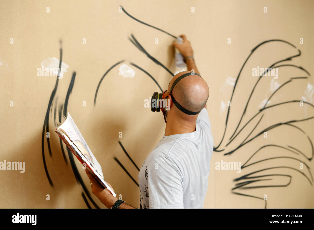 Anonimous artist Graffitti painter during an exhibit in the Spanish island of Majorca Stock Photo