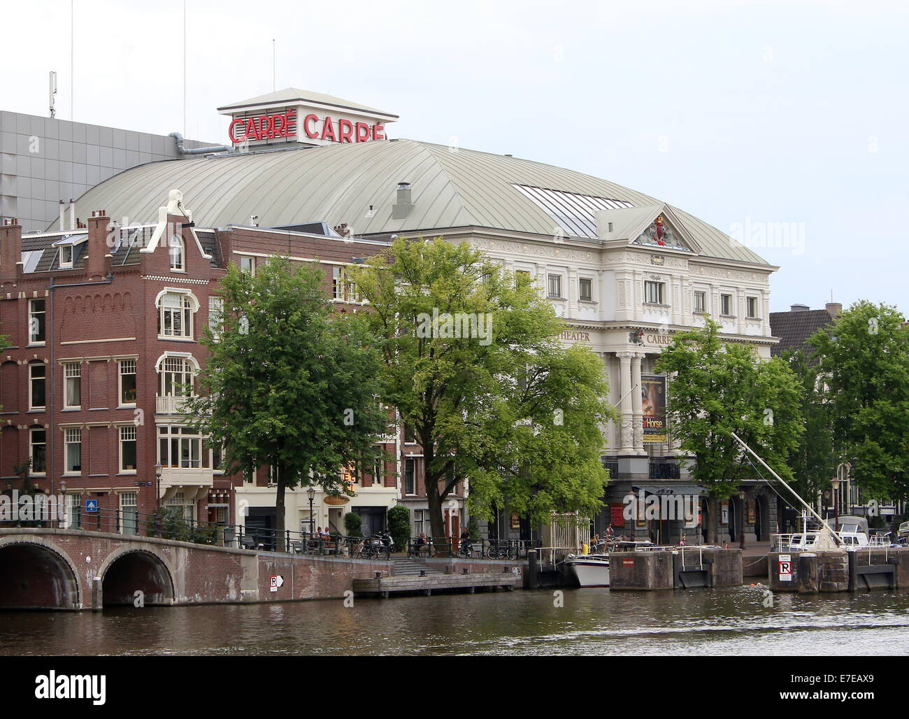 Late 19th century Royal Theatre Carré in Amsterdam, The Netherlands, along the Amstel river banks Stock Photo