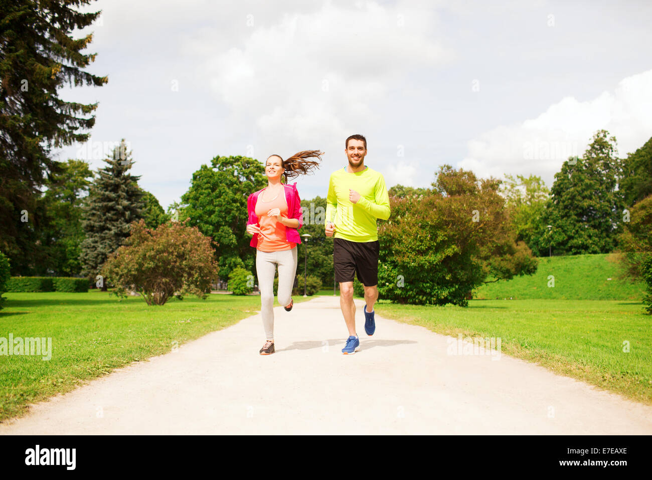 smiling couple running outdoors Stock Photo - Alamy
