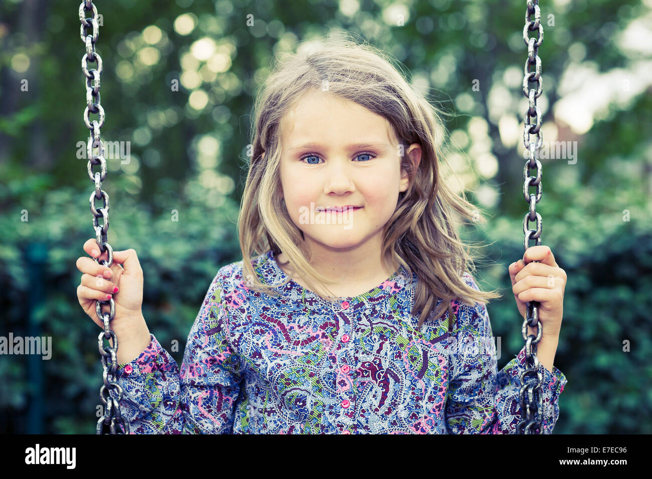 Girl on swing in summer park Stock Photo