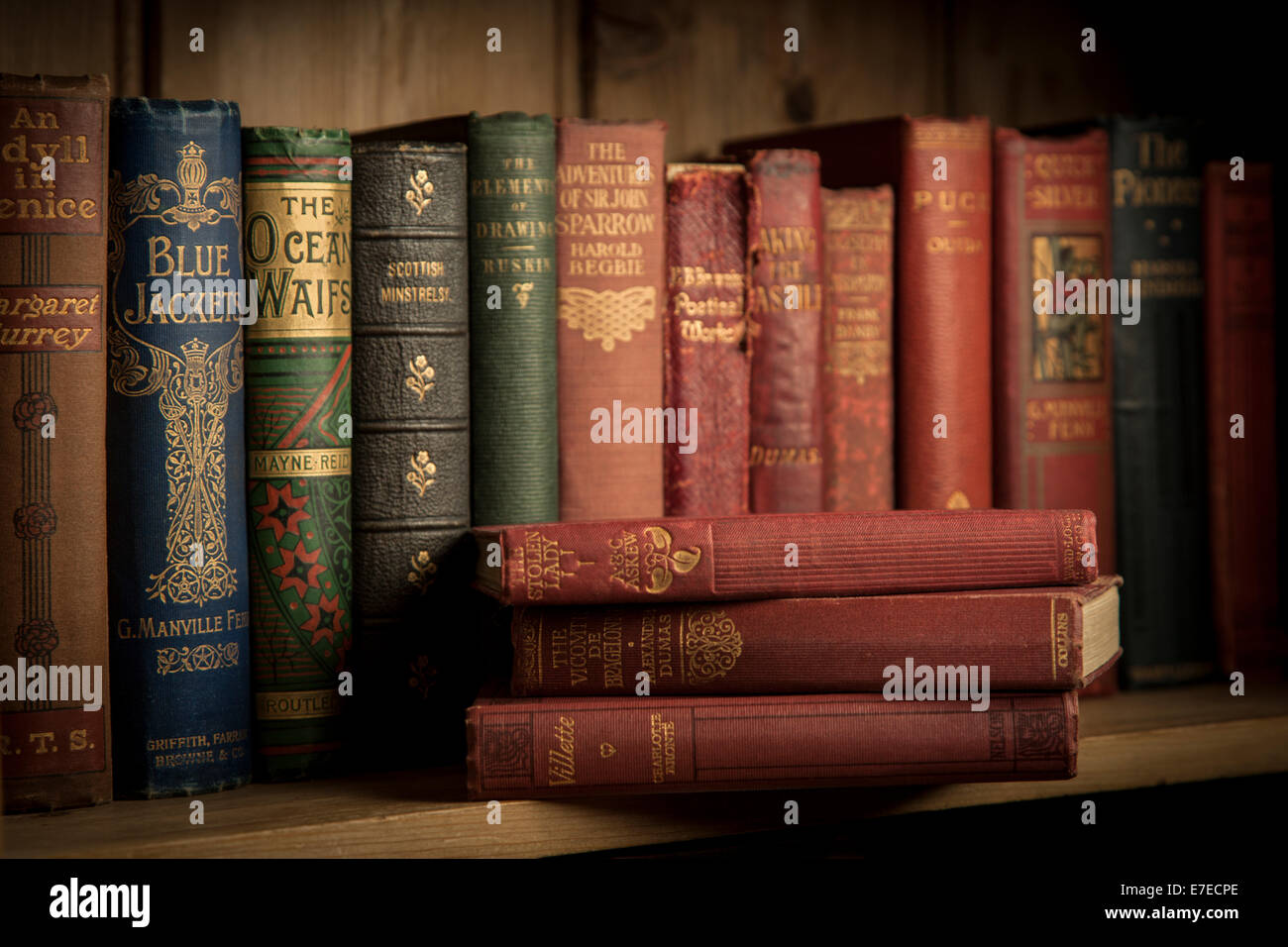 Vintage hardback books on a wooden bookshelf Stock Photo Alamy