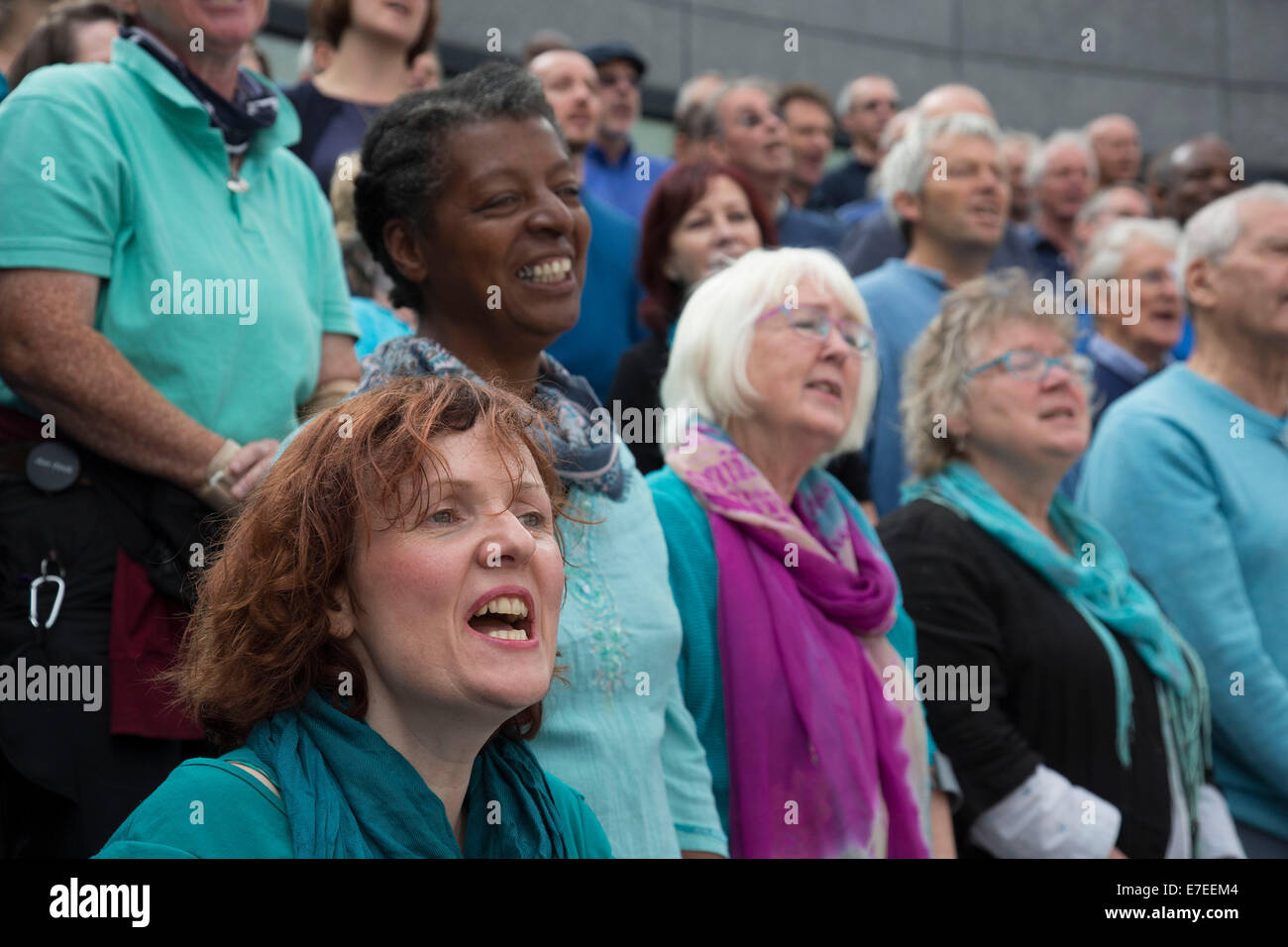 Adults choir, made from choirs from all over the region, perform at The Scoop. Totally Thames Festival, London, UK. Stock Photo