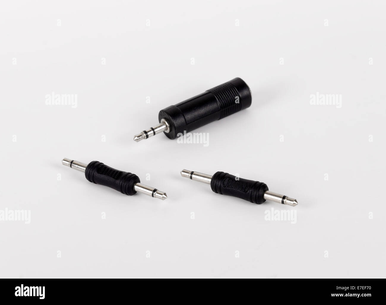 Three different stereo adapters minijacks (3.5 mm) on white background