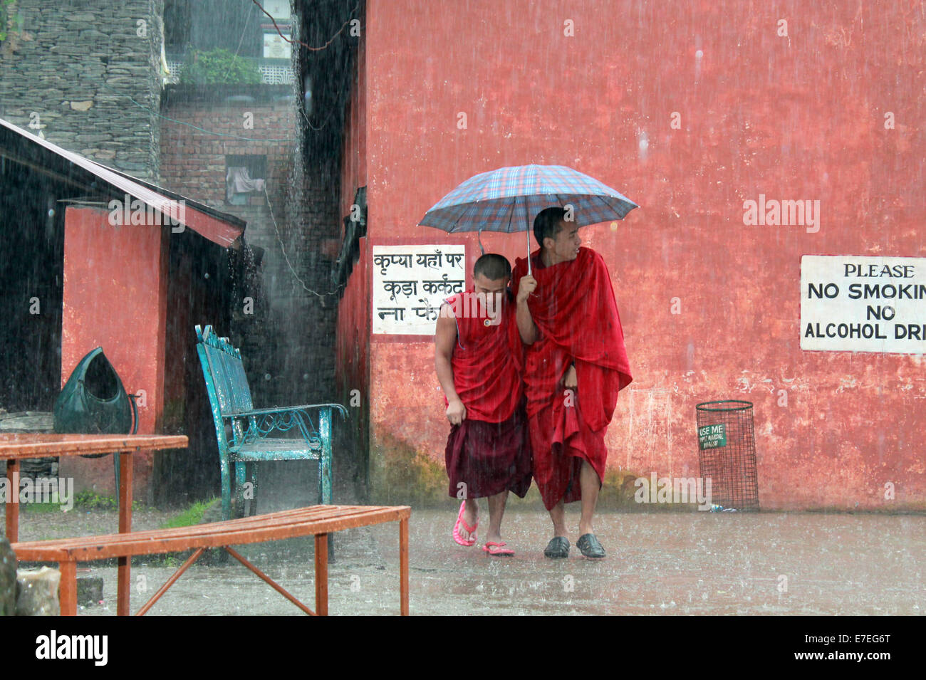 Tibetan monks escaping rainfall Stock Photo