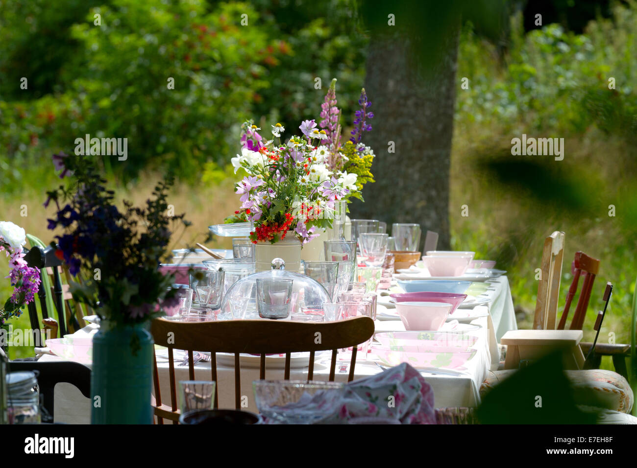 Outdoor table with nice colorful flowers Stock Photo