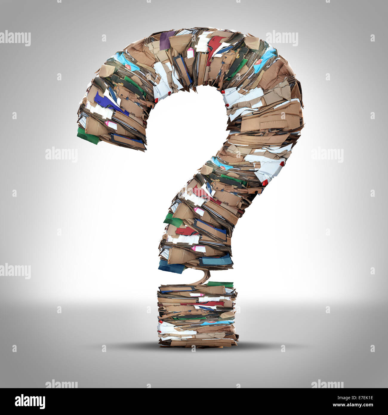 Recycle Cardboard Paper Questions and recycling cardboard packaging concept with stacks of compressed corrugated paper garbage shaped as a question mark as a symbol for conservation and environmental technology business issues. Stock Photo