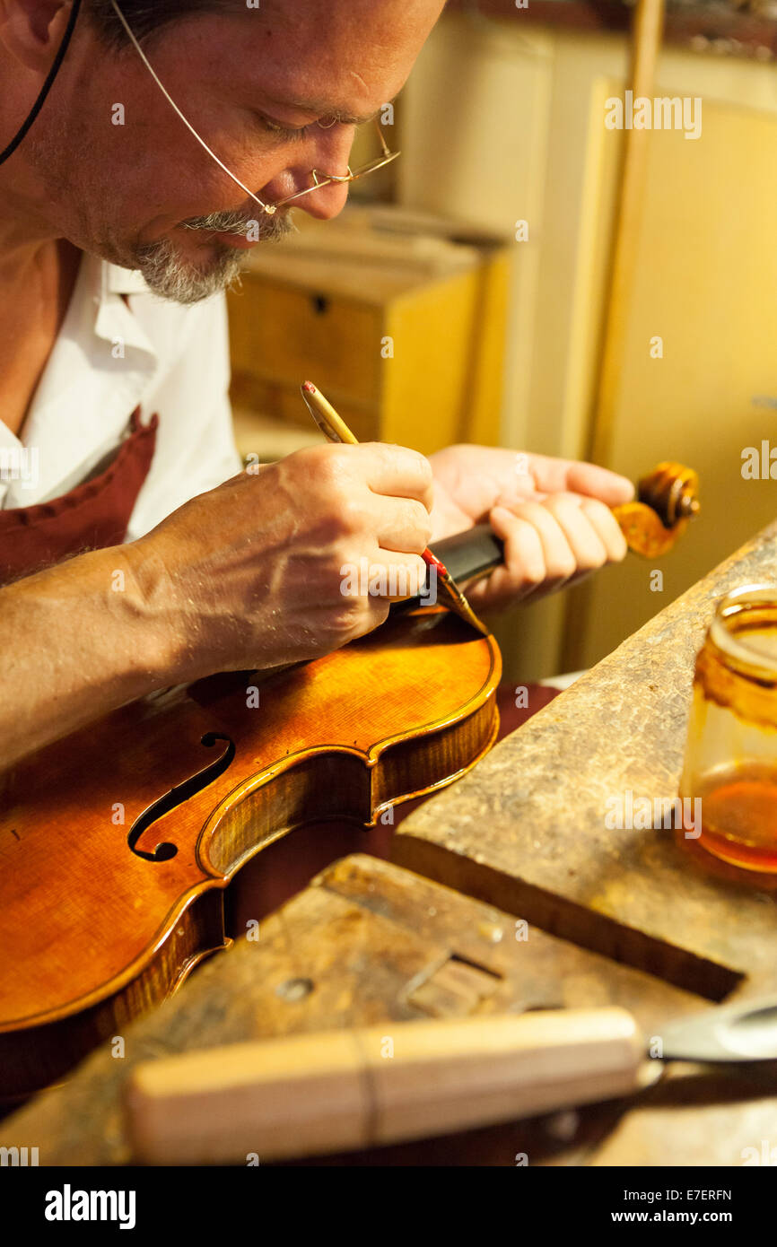 Violin maker in workshop in Rome Stock Photo