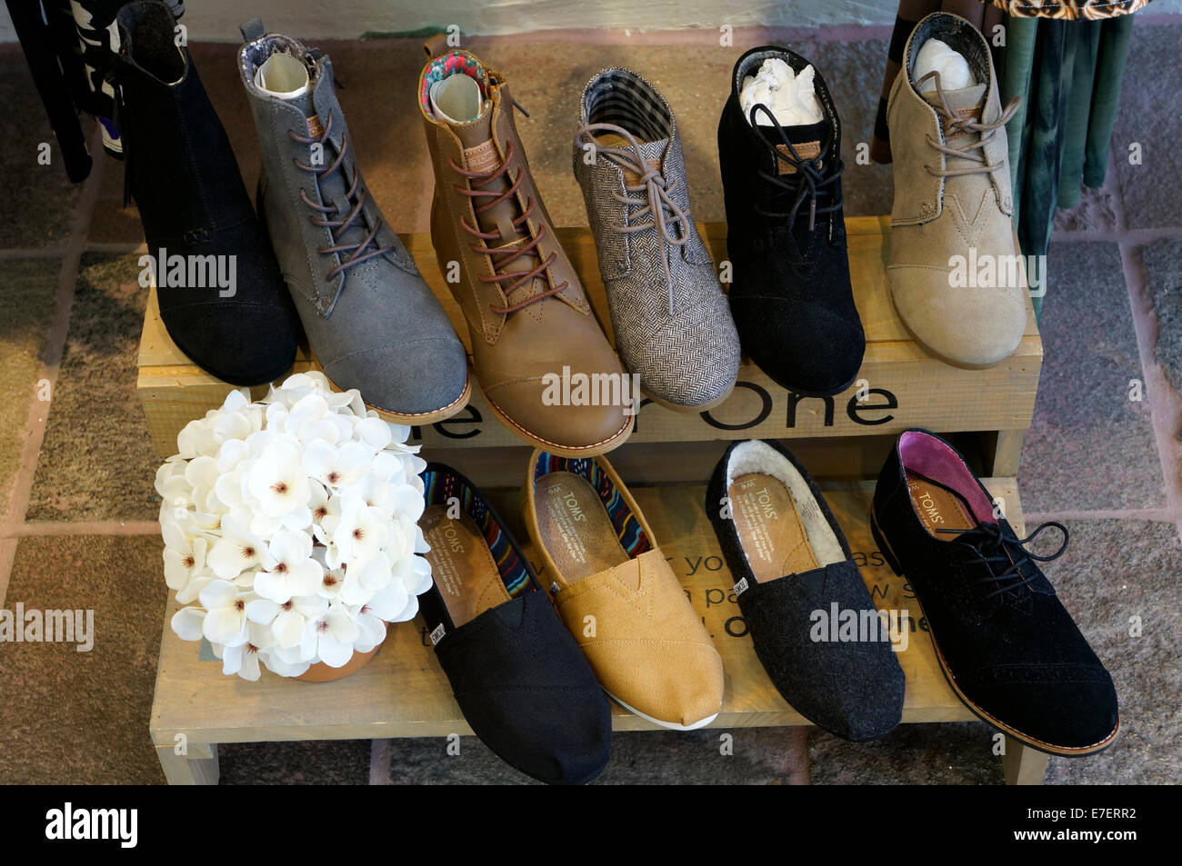 Stylish women's casual boots and shoes for sale in a store Stock Photo