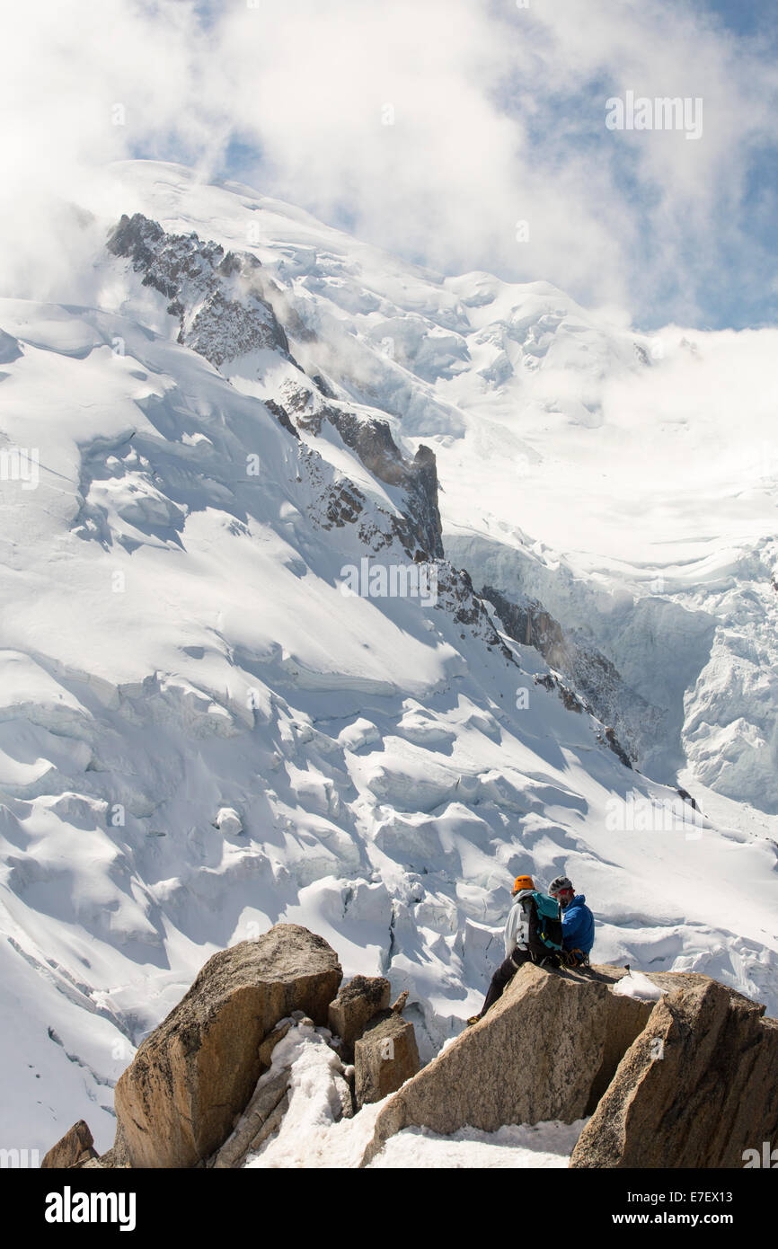Mont Blanc and the Bossons glacier from the Aiguille Du Midi, France, with climbers on the Cosmiques Arete. Stock Photo