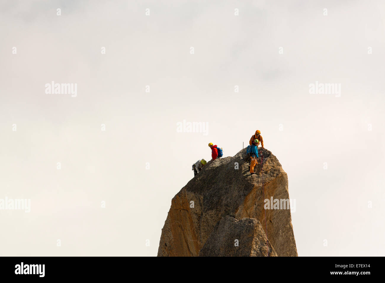 Climbers on a pinnalce on the Aiguille du Midi above Chamonix, France. Stock Photo