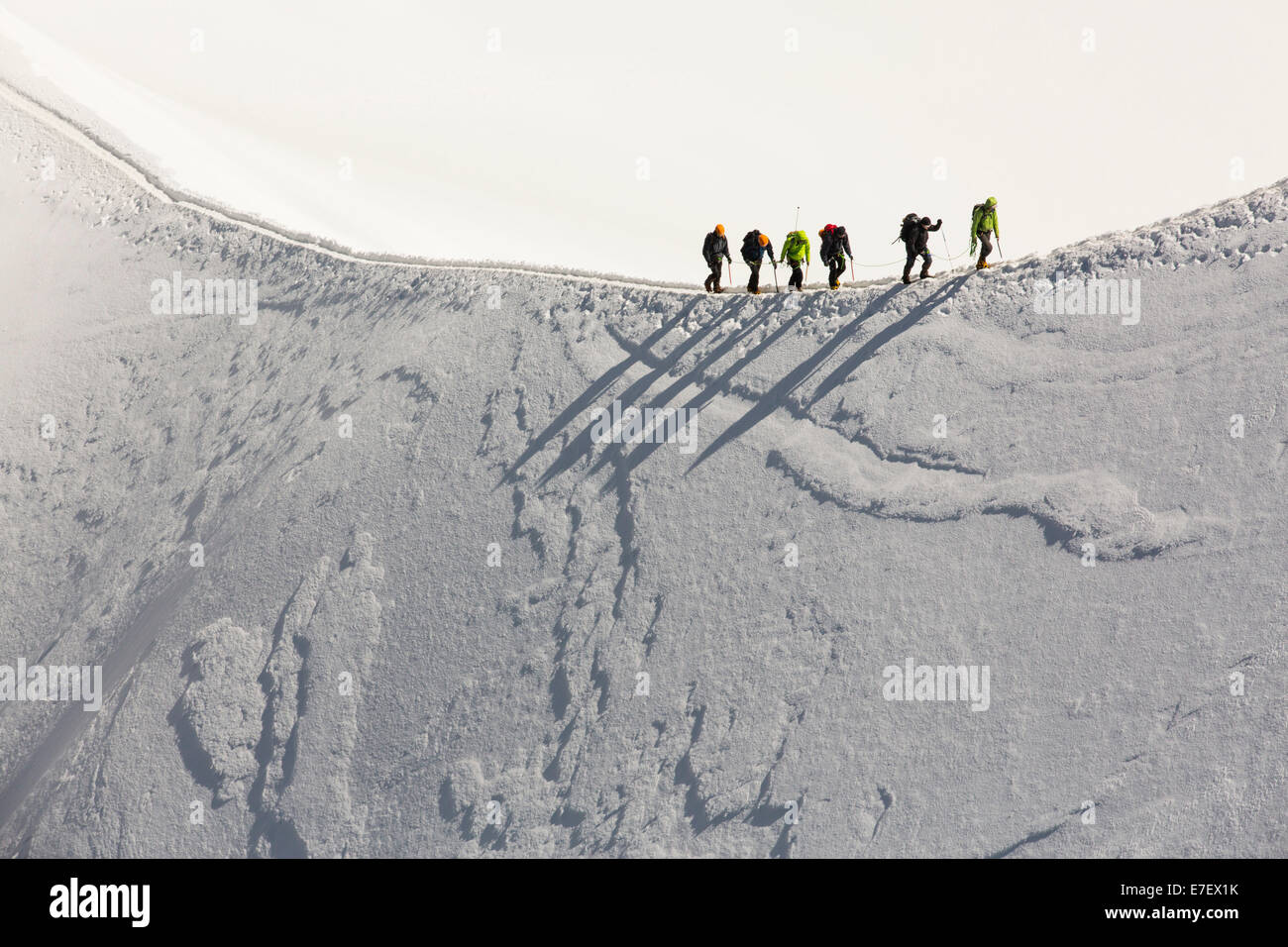 Climbers on the arete leading up from the Vallee Blanche to the Aiguille Du Midi above Chamonix, France. Stock Photo