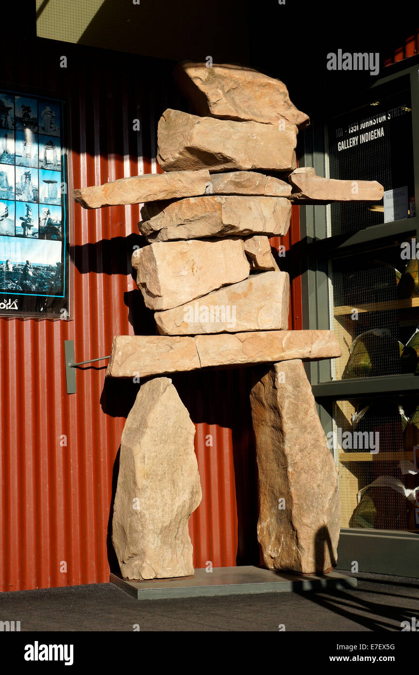 Inuit stone inukshuk or inuksuk outside a native first nations art gallery on Granville Island, Vancouver, British Columbia, Canada Stock Photo