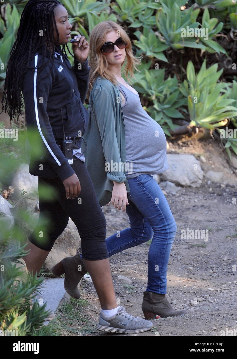 Isla Fisher shows off her huge pregnant belly bump while on the set of her new movie 'Visions' filming in Highland Park Ca. The actress seemed to be having a hard time getting into to her classic car for a scene with her huge prosthetic belly.  Featuring: Isla Fisher Where: Highland Park, California, United States When: 13 Mar 2014 Stock Photo