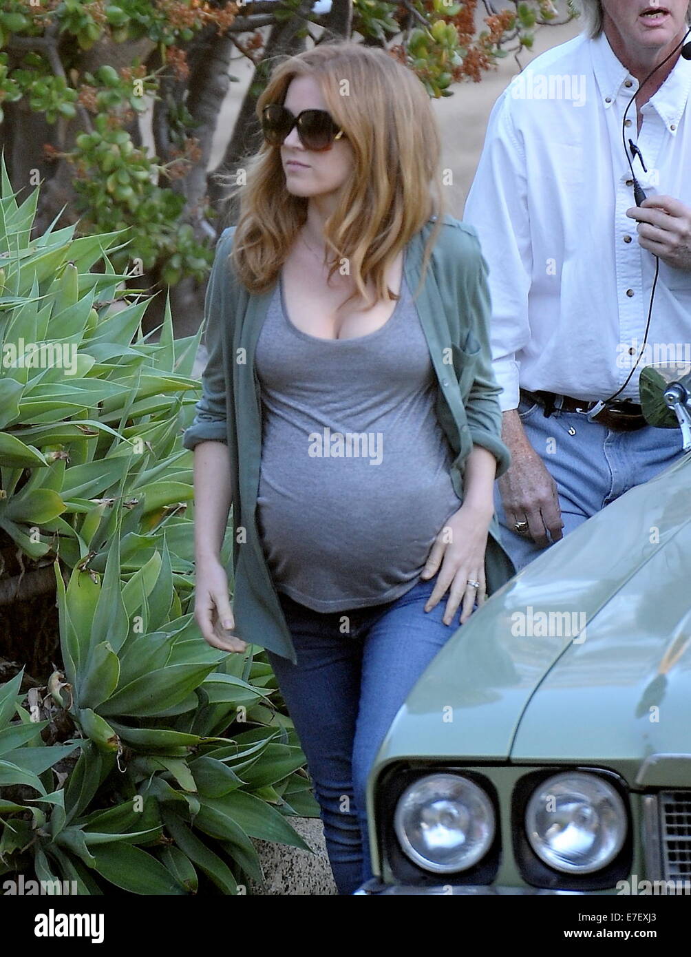 Isla Fisher shows off her huge pregnant belly bump while on the set of her new movie 'Visions' filming in Highland Park Ca. The actress seemed to be having a hard time getting into to her classic car for a scene with her huge prosthetic belly.  Featuring: Isla Fisher Where: Highland Park, California, United States When: 13 Mar 2014 Stock Photo