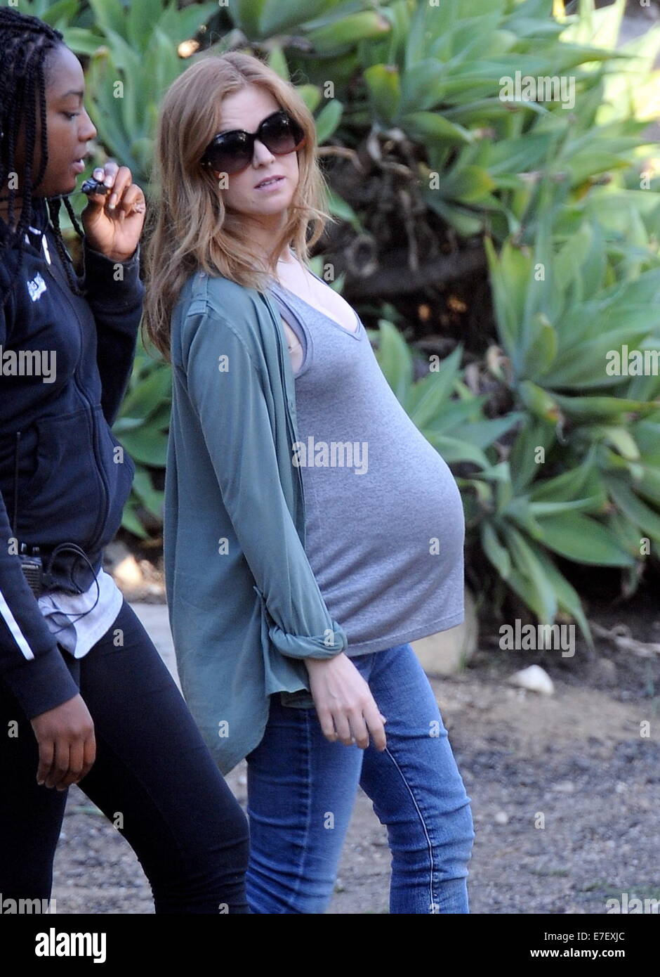 Isla Fisher shows off her huge pregnant belly bump while on the set of her new movie 'Visions' filming in Highland Park Ca. The actress seemed to be having a hard time getting into to her classic car for a scene with her huge prosthetic belly.  Featuring: Isla Fisher Where: Highland Park, California, United States When: 13 Mar 2014 Stock Photo
