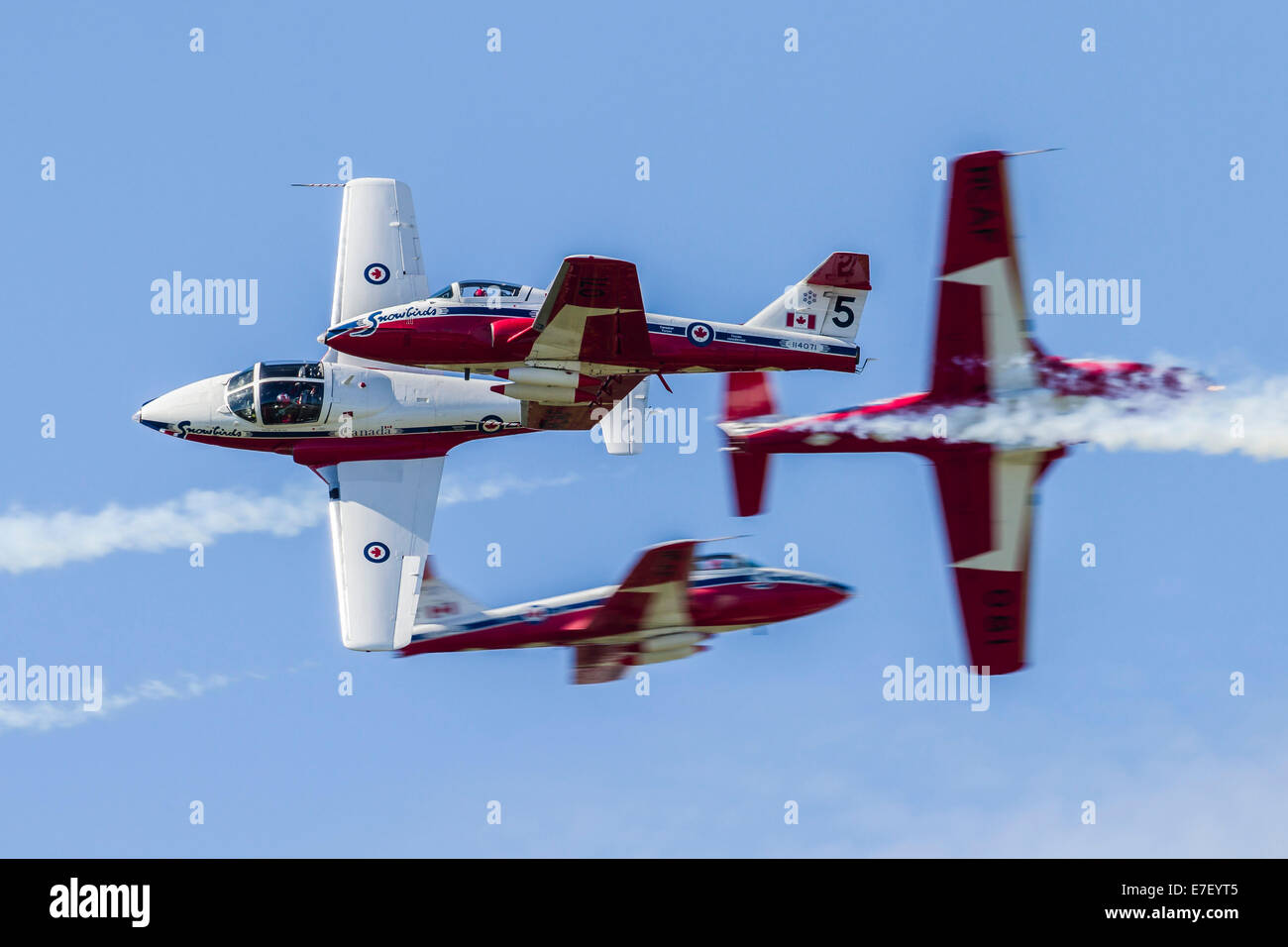 Four Royal Canadian Air Force Tutor trainer aircraft of the Snowbirds display team cross at Waukegan, Illinois. Stock Photo