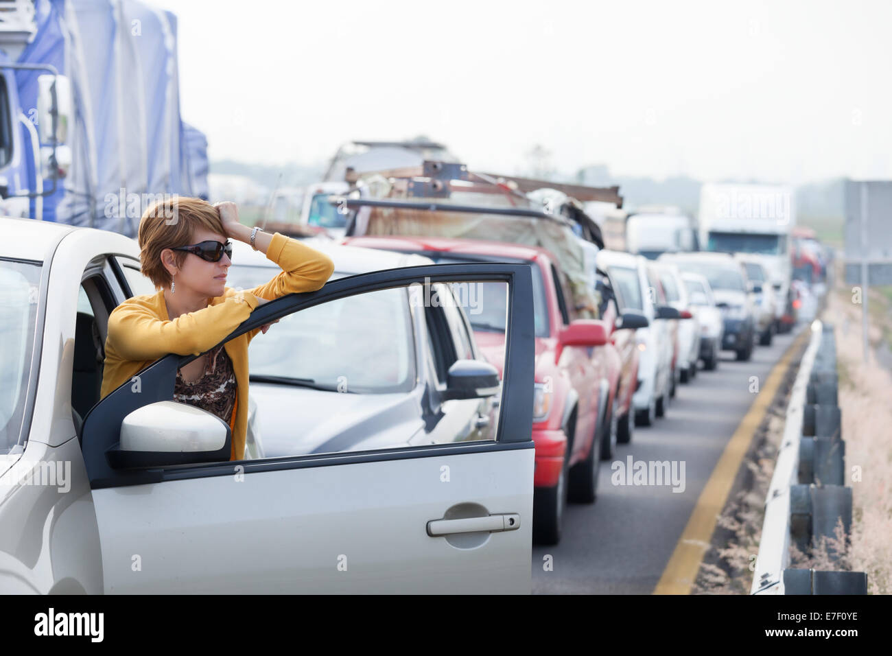 Frustrated middle aged Hispanic woman stuck in a traffic jam. Stock Photo