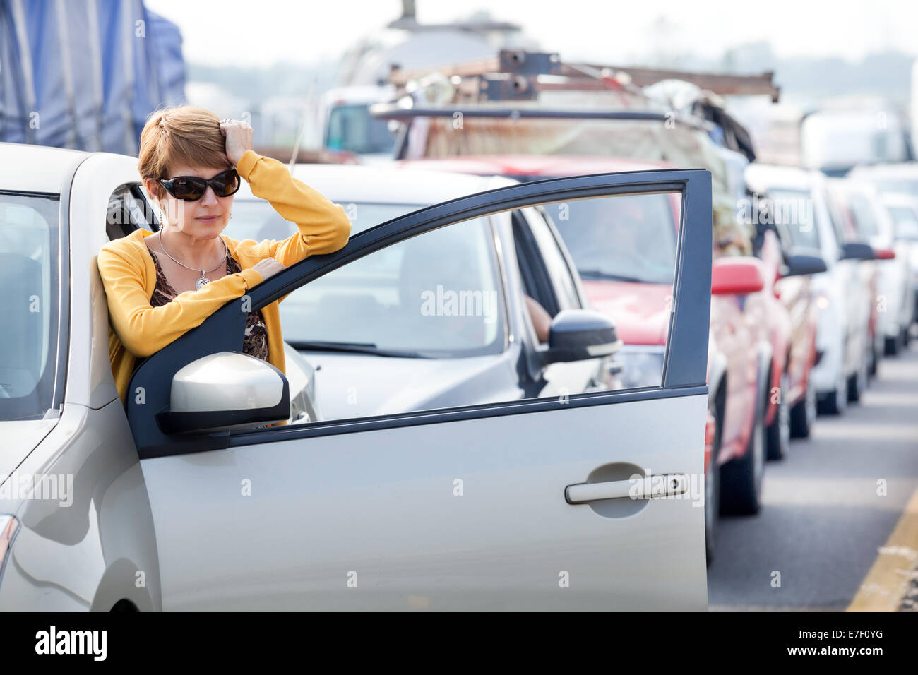 Frustrated middle aged Hispanic woman stuck in a traffic jam. Stock Photo