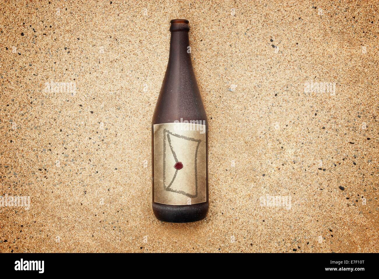 Vintage version of washed out bottle on a gravel beach, with envelope and seal on  label Stock Photo