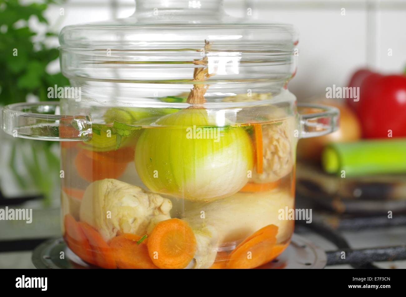 hot soup in glass pot in kitchen Stock Photo Alamy