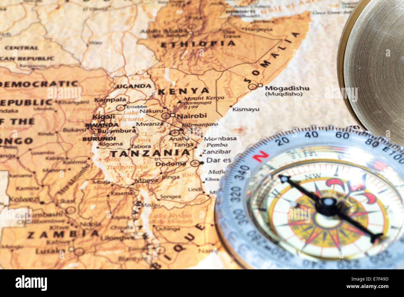 Compass on a map pointing at Tanzania and Kenya, planning a travel destination Stock Photo