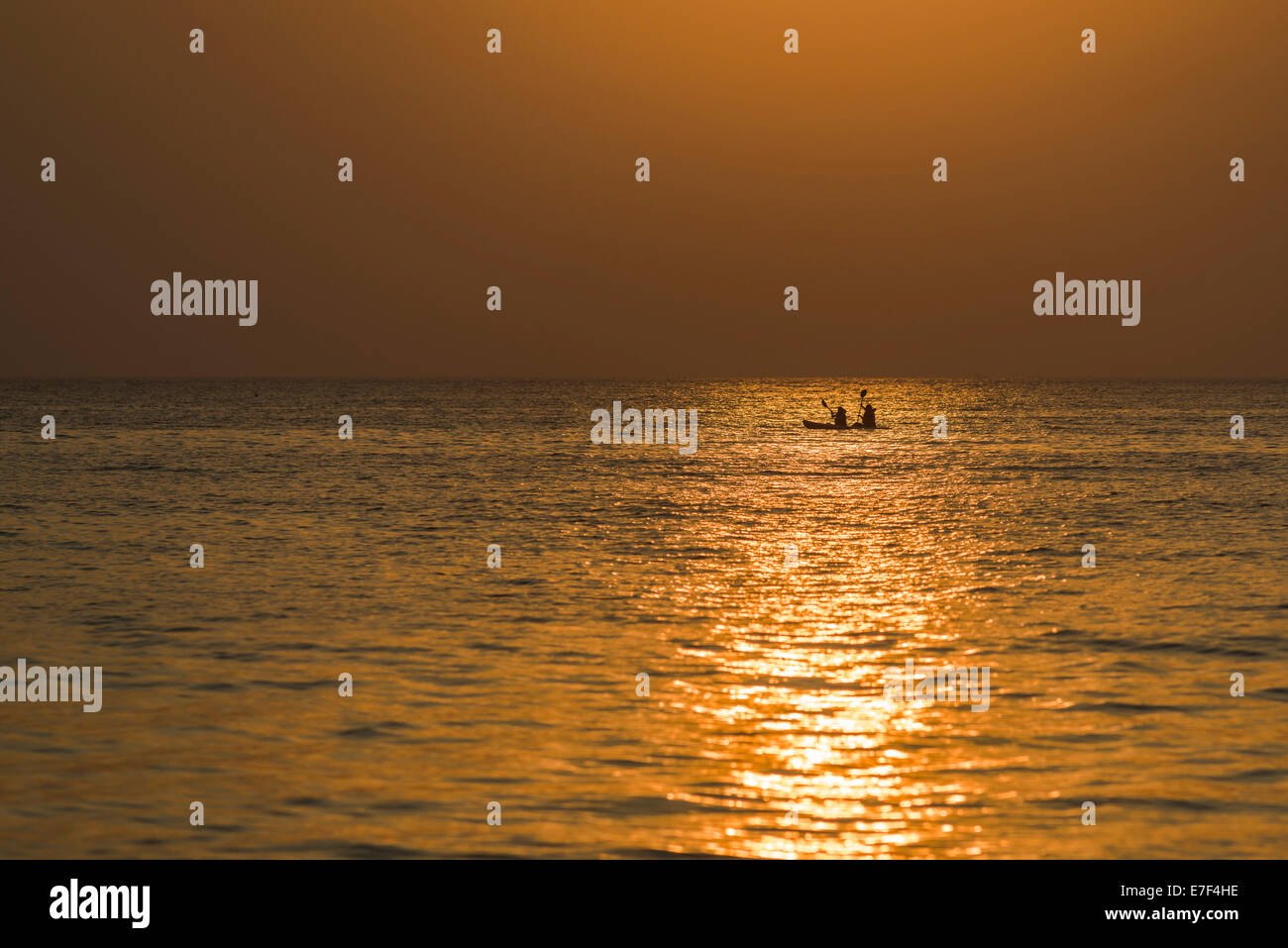 Two kayakers in the open sea at sunset, Palolem Beach, Canacona, Goa, India Stock Photo