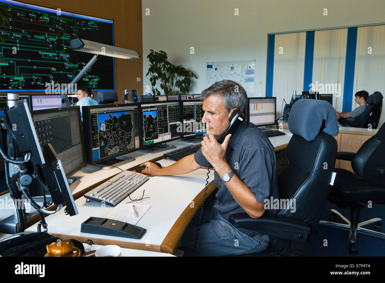 Shift supervisor Hans-Peter Polzer sitting at his work station in the Transmission Control Center, TCC, of transmission network Stock Photo