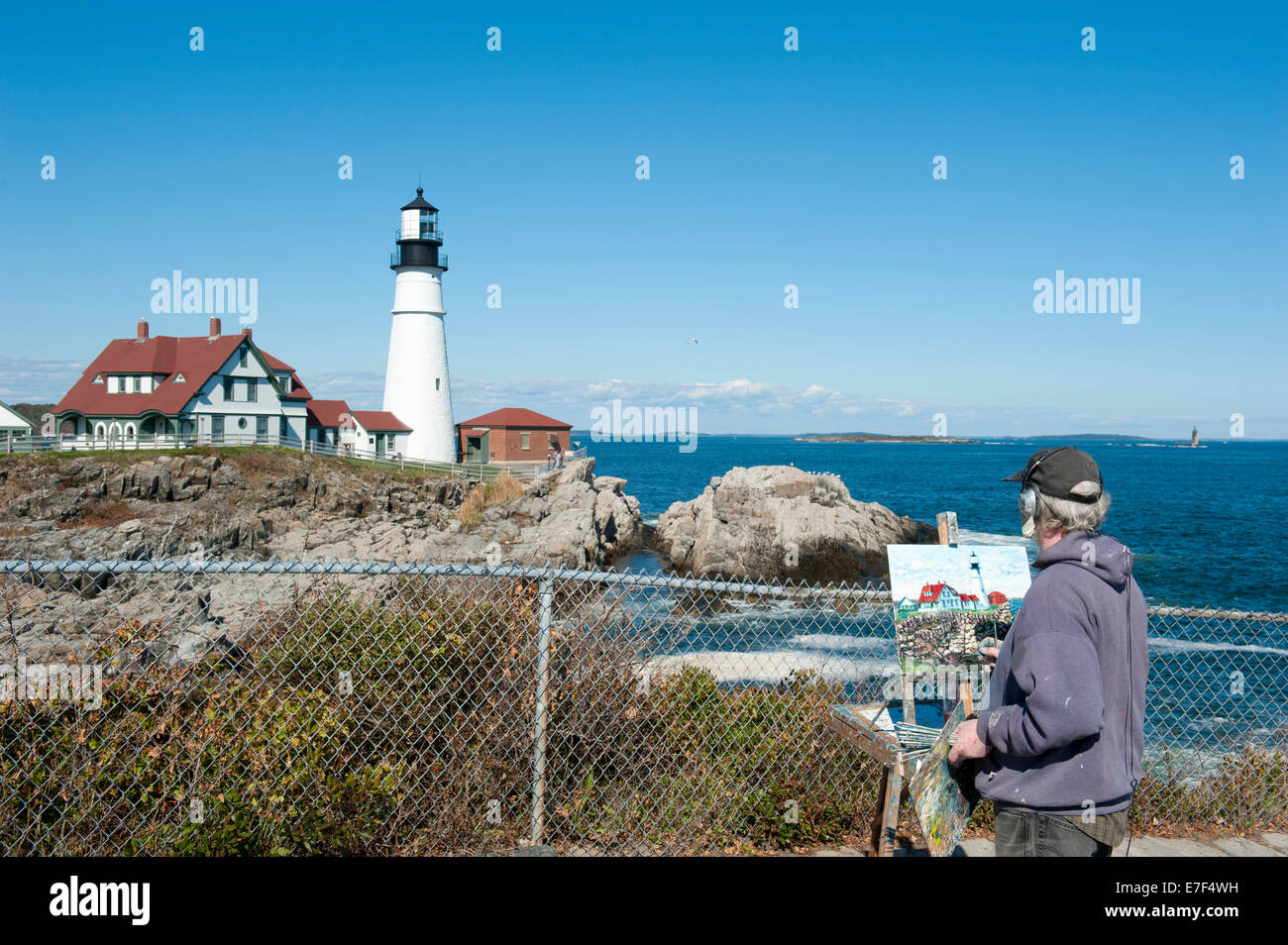 Painter painting a lighthouse, Portland Head Light, Cape Elizabeth, Portland, Maine, New England, USA Stock Photo