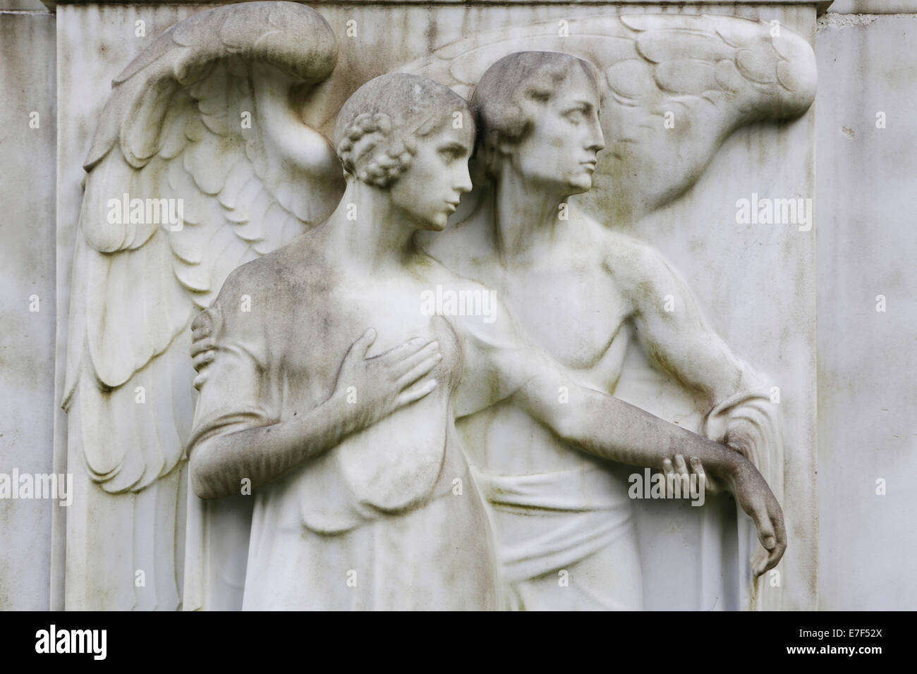 Angel and a female figure on a gravestone, Melatenfriedhof cemetery, Cologne, North Rhine-Westphalia, Germany Stock Photo