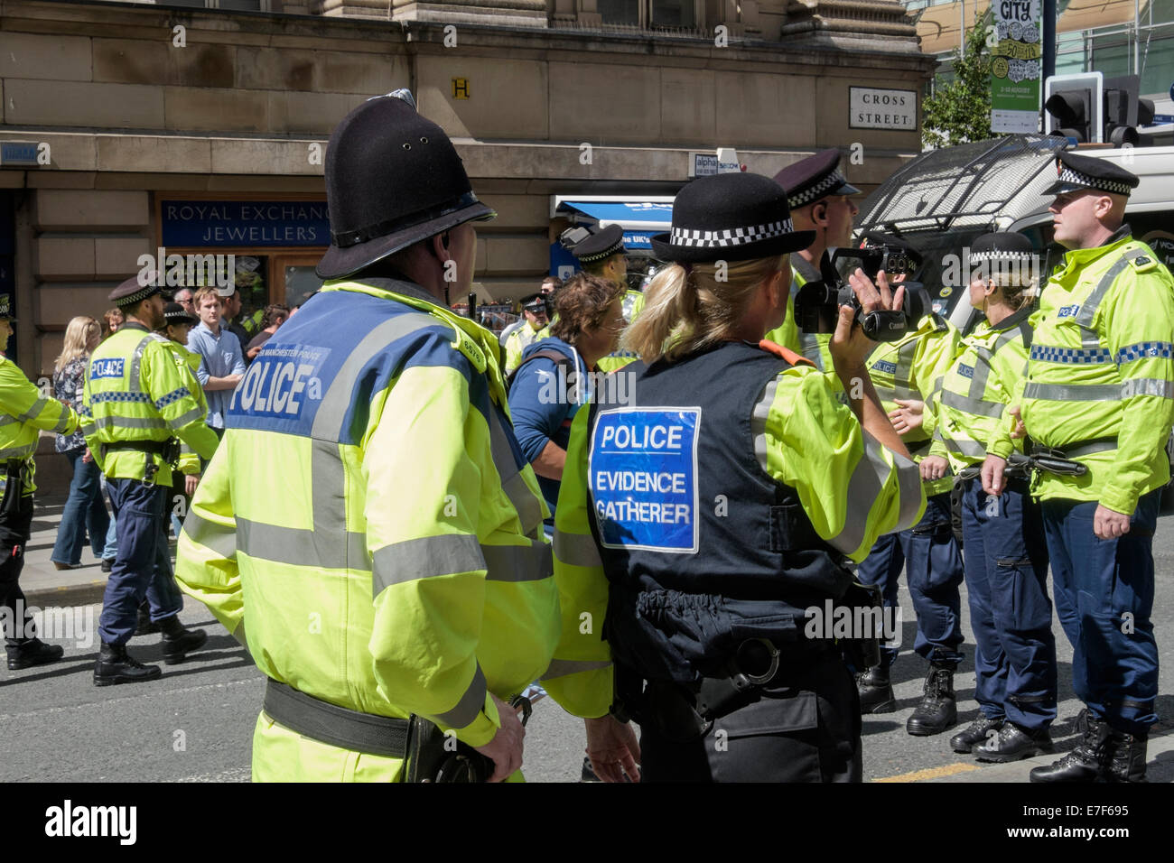 A police evidence gatherer uses a video camera to carry out overt surveillance on the pro Gaza protest. Manchester, England, UK Stock Photo