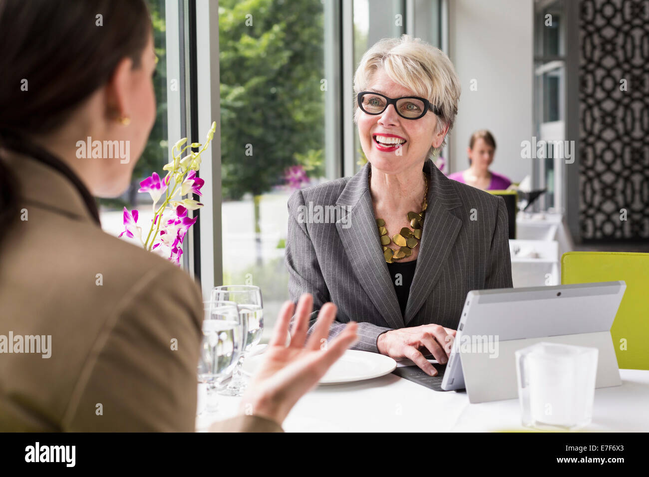 Caucasian businesswomen working in restaurant Stock Photo