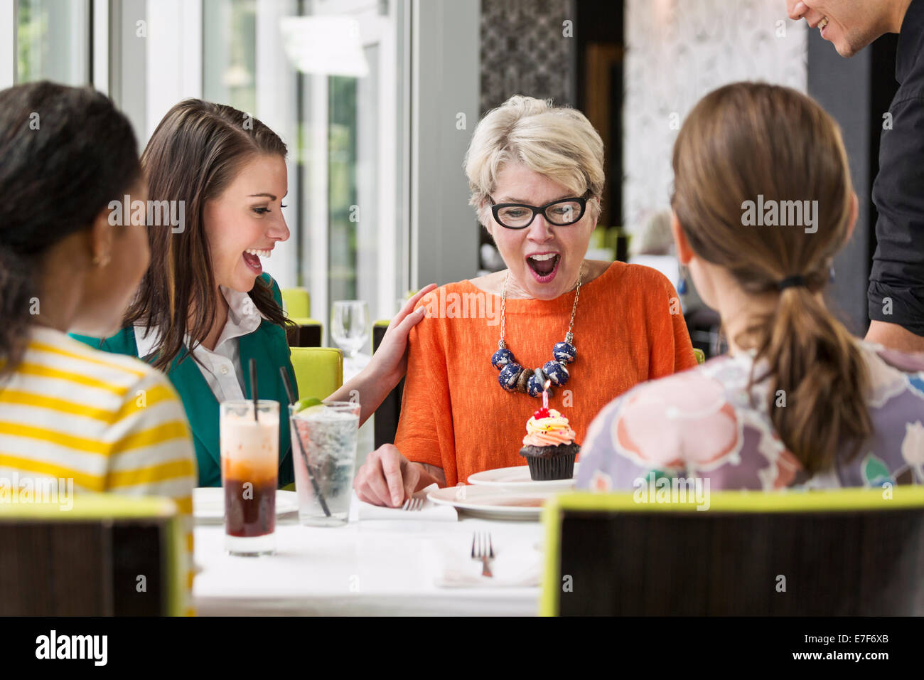 Women celebrating birthday in restaurant Stock Photo