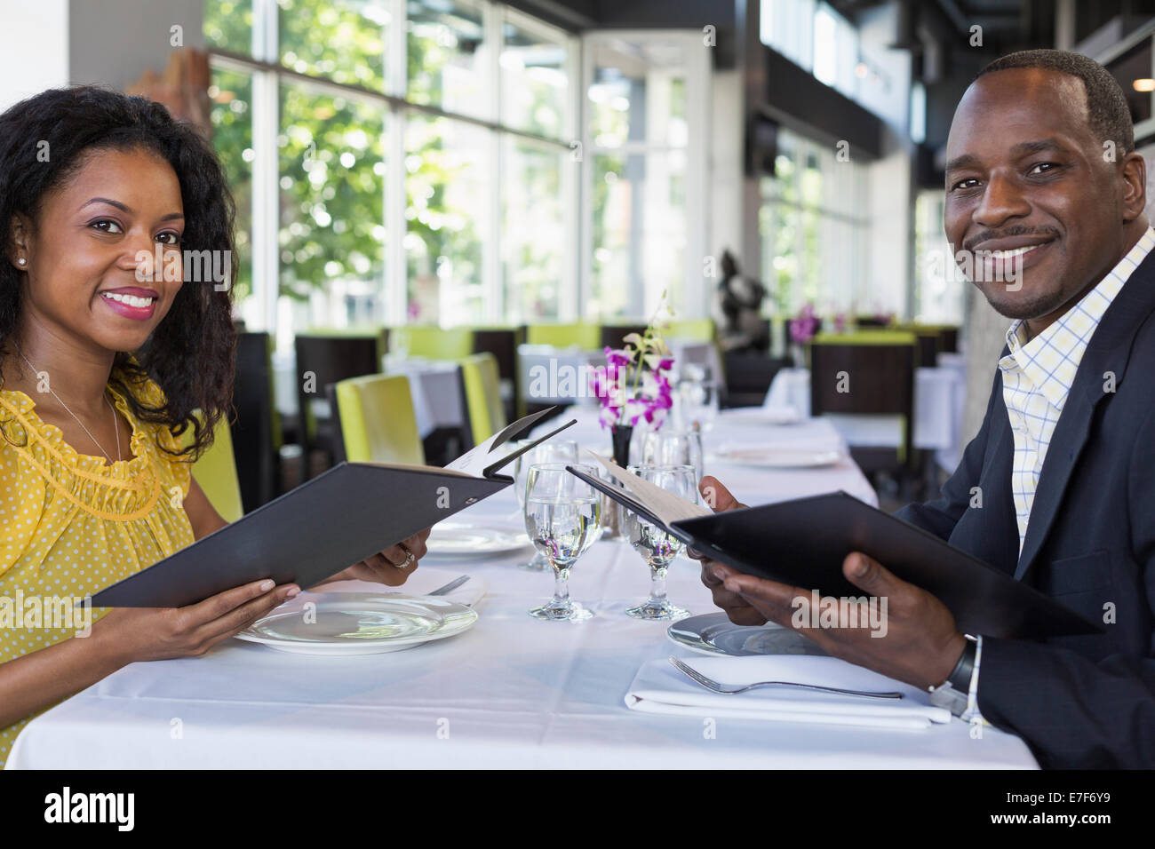 African American couple smiling in restaurant Stock Photo