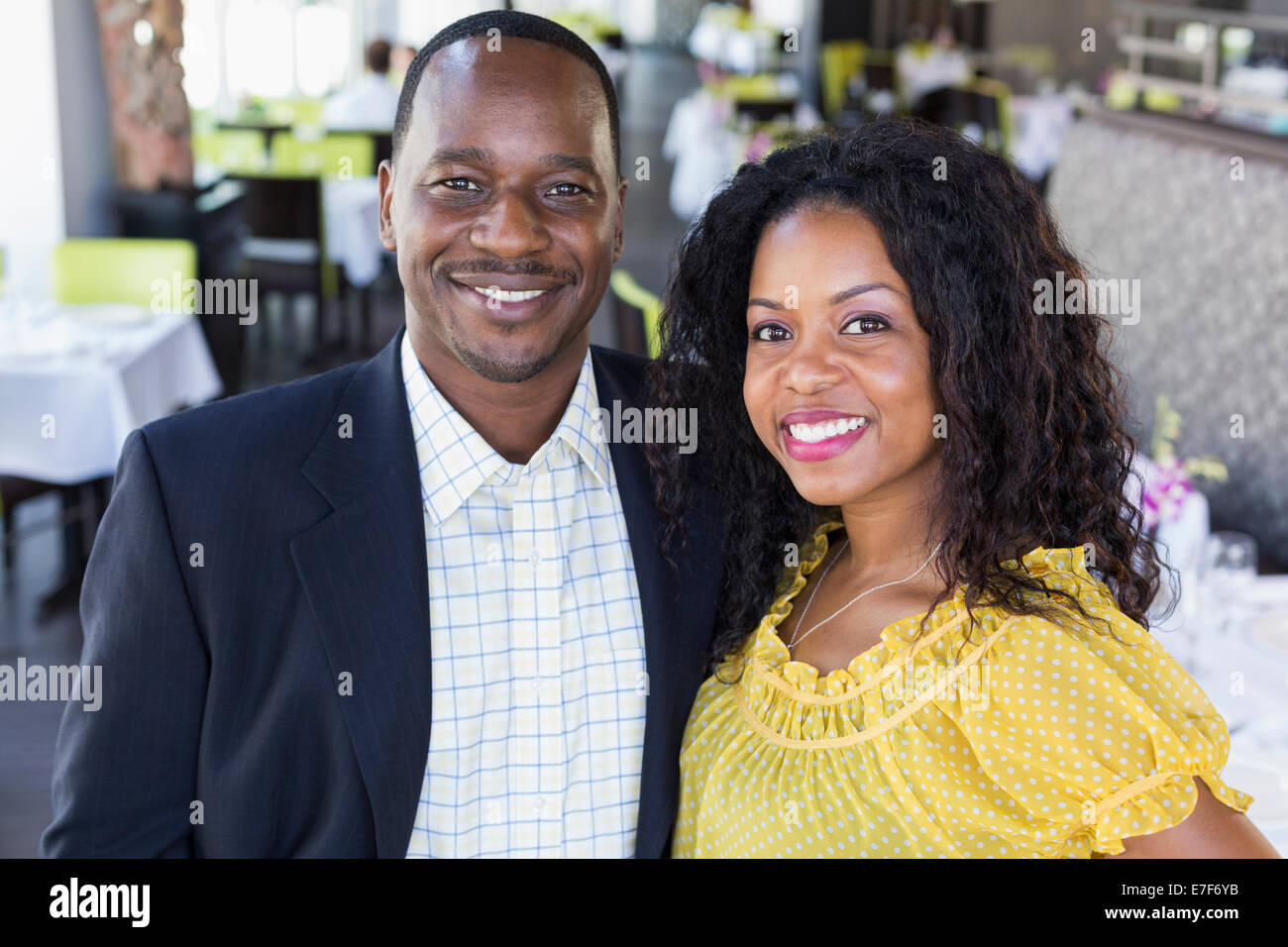 African American couple smiling in restaurant Stock Photo