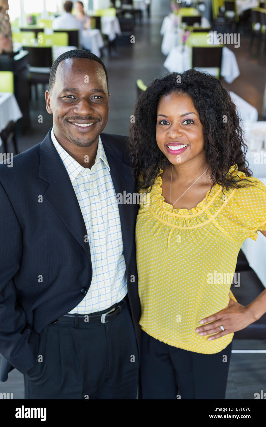 African American couple smiling in restaurant Stock Photo