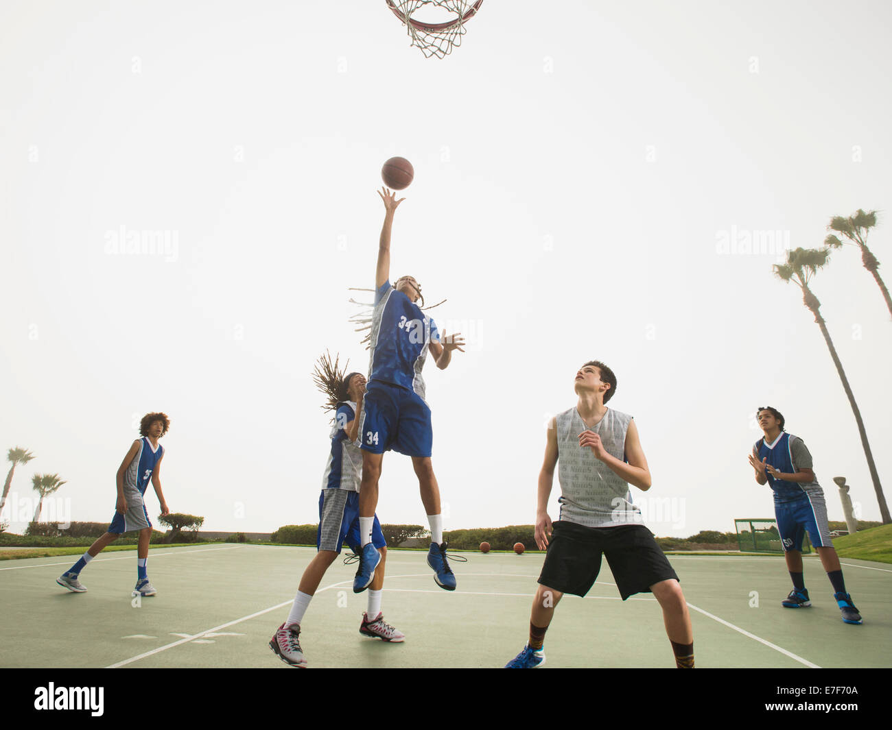 Basketball teams playing on court Stock Photo