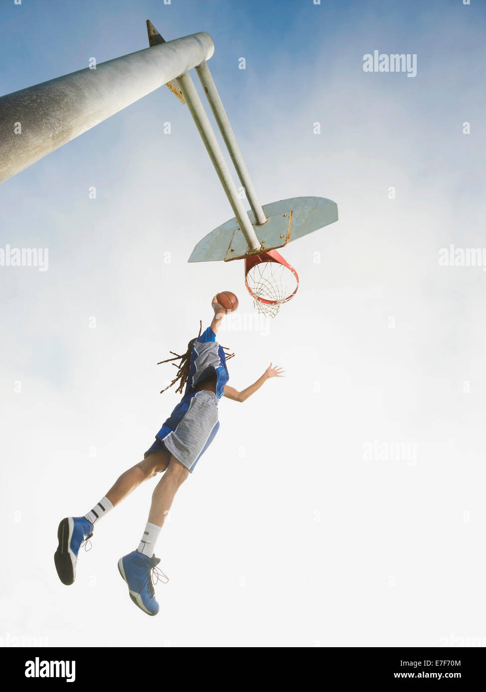 Black basketball player dunking ball in hoop Stock Photo