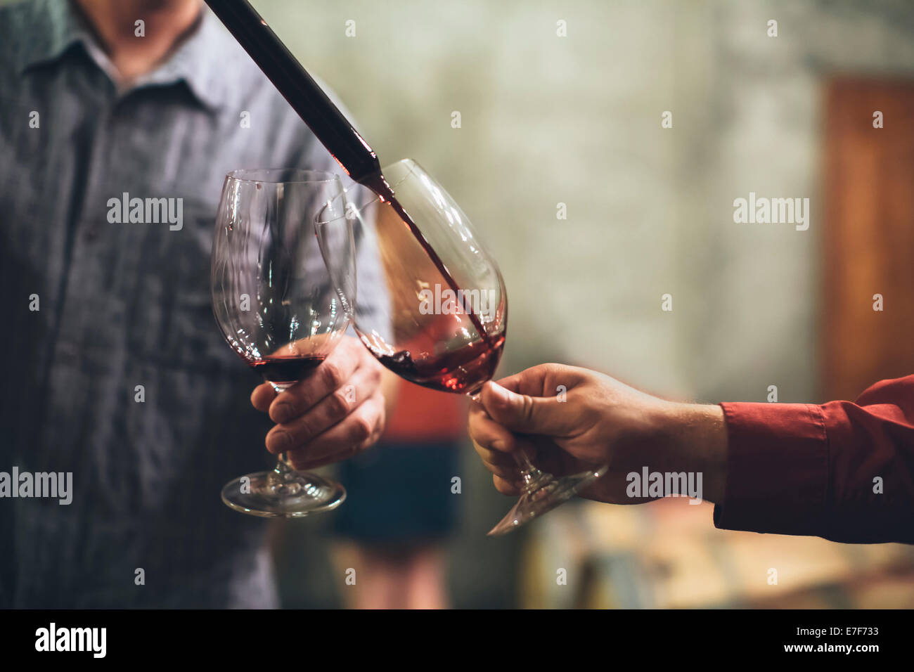 Caucasian men tasting wine in cellar Stock Photo - Alamy