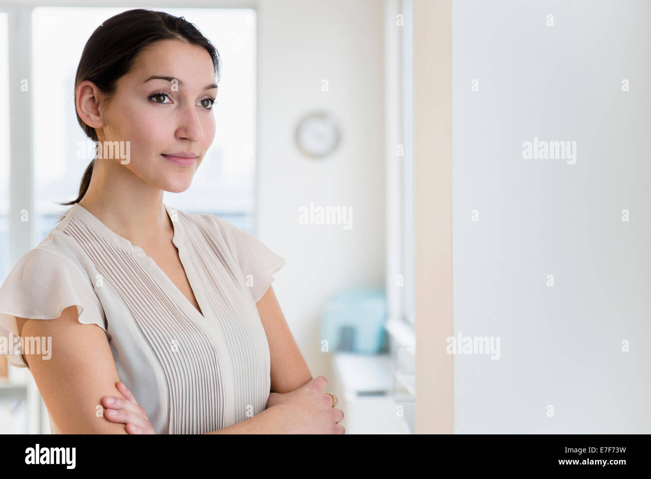 Caucasian businesswoman standing in office Stock Photo