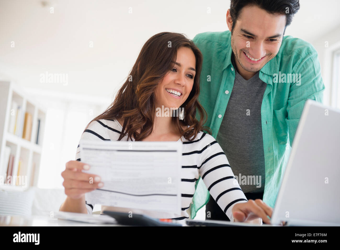 Couple paying bills together online Stock Photo