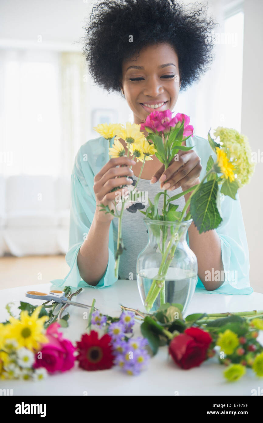 African American woman arranging flowers Stock Photo
