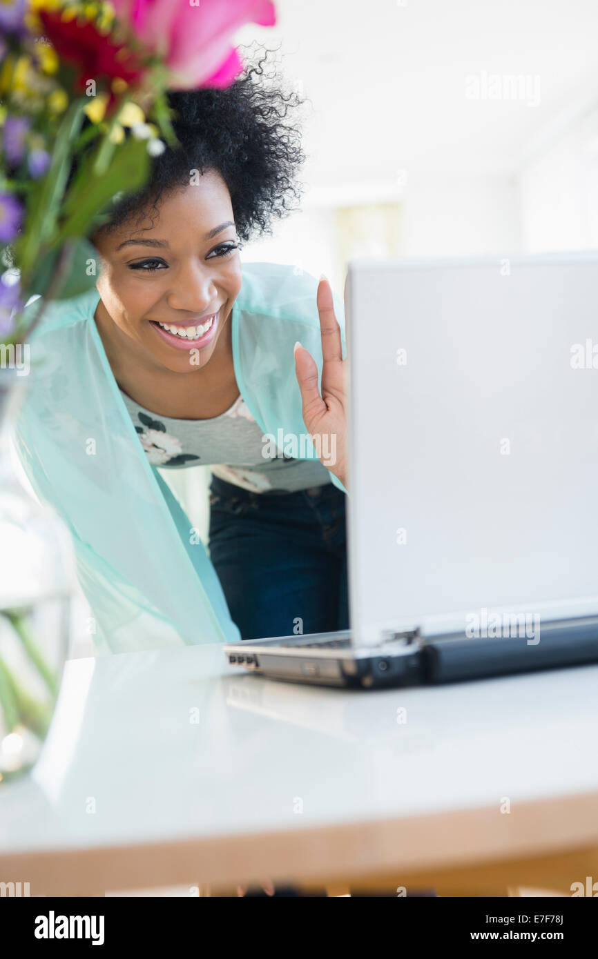 African American woman video chatting with laptop Stock Photo
