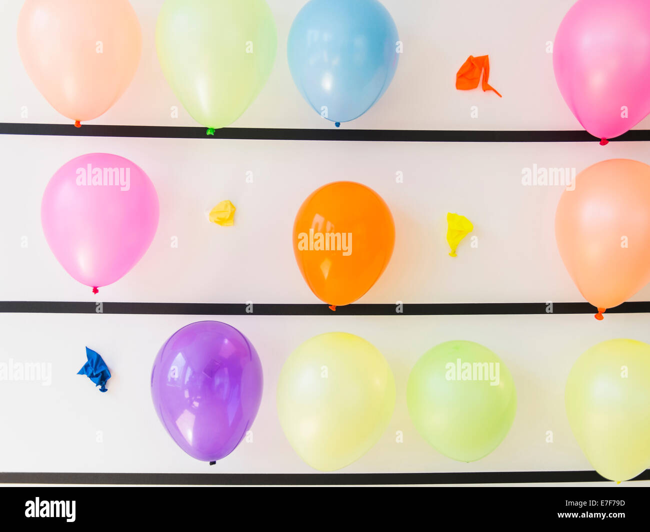 Popped balloons on wall Stock Photo