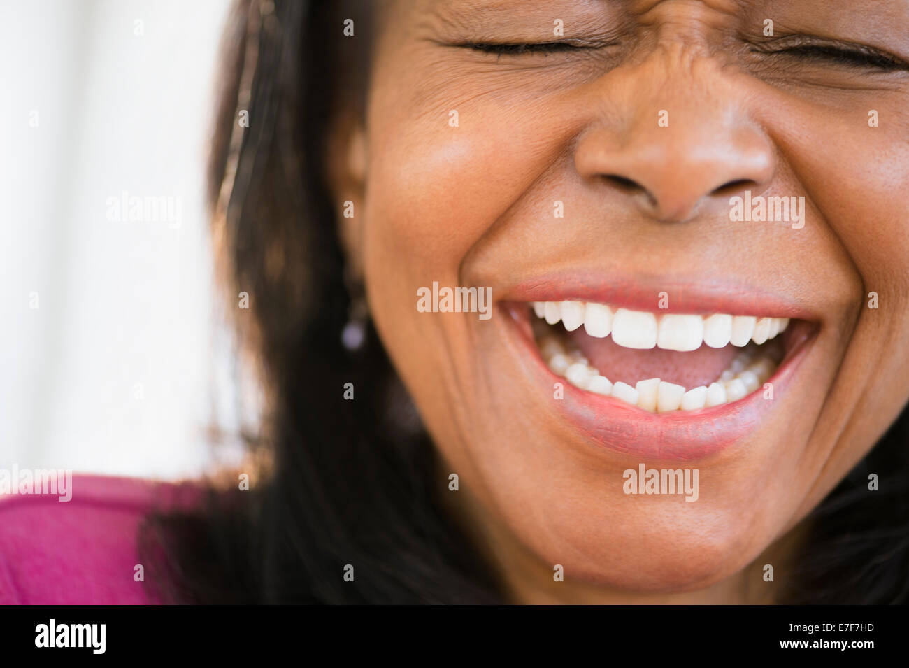 Close up of mixed race woman laughing Stock Photo