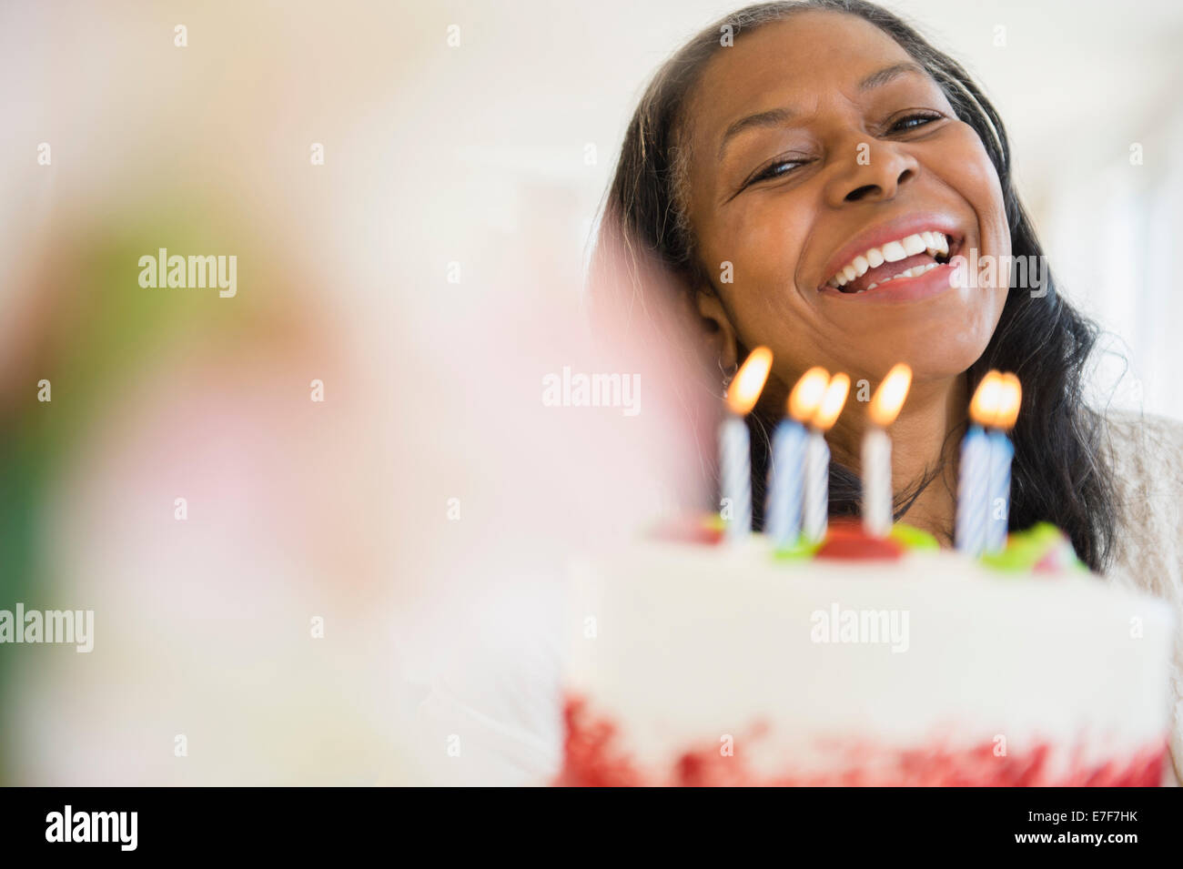 Mixed race woman celebrating birthday Stock Photo