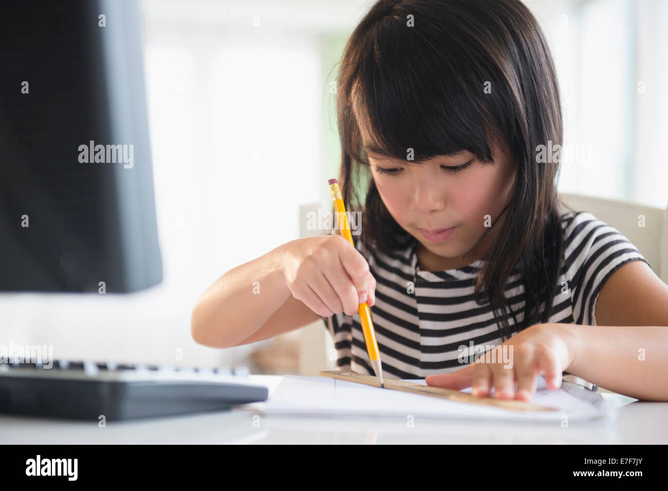 Filipino girl drawing at computer Stock Photo