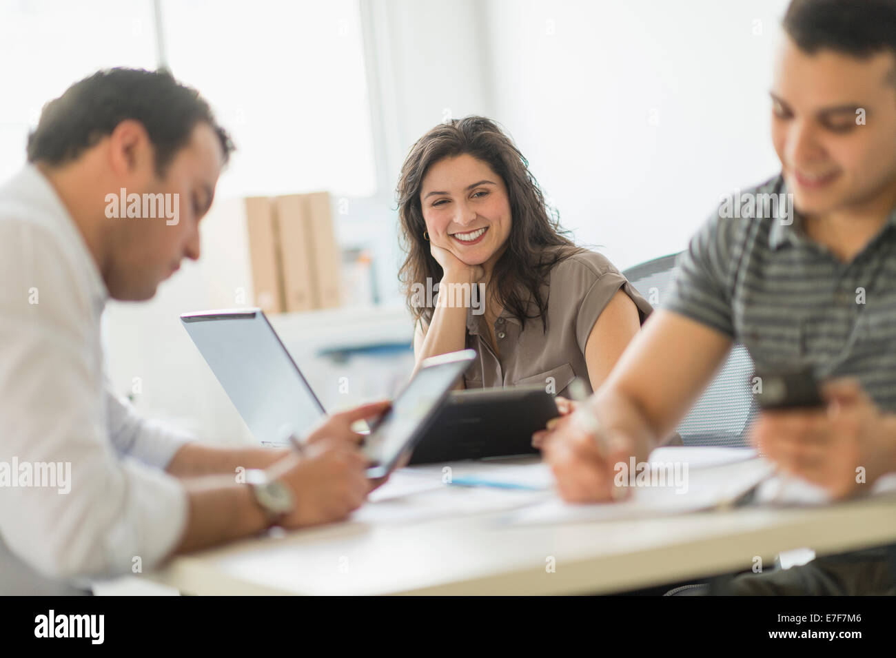 Hispanic business people working in office Stock Photo