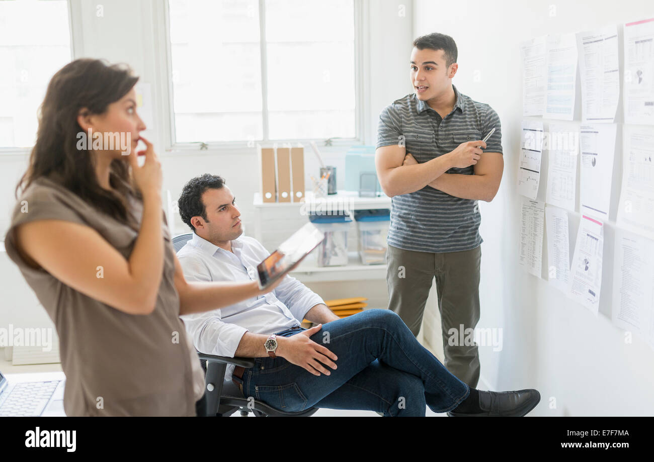Hispanic business people working together in office Stock Photo