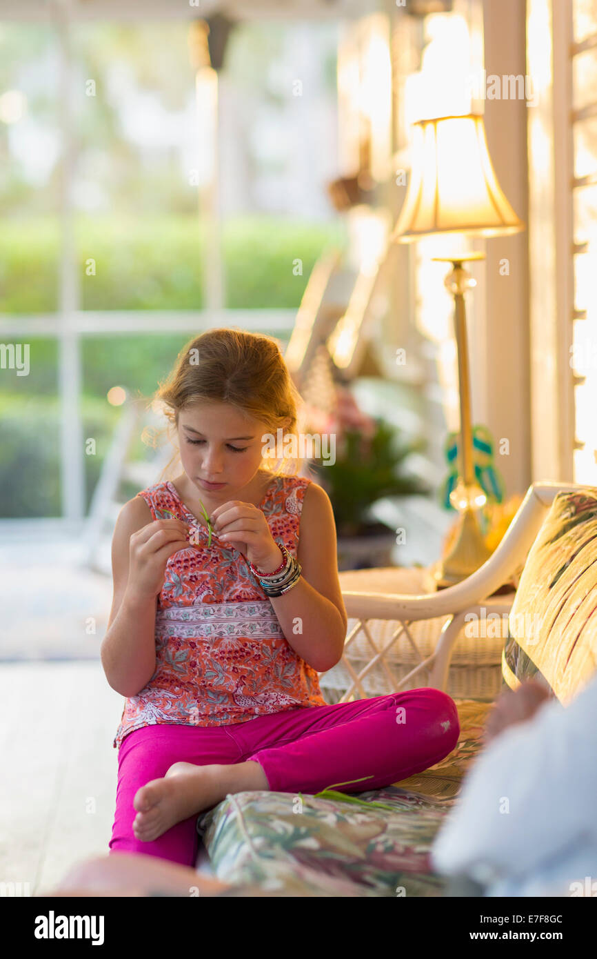 Caucasian girl sitting on patio Stock Photo Alamy