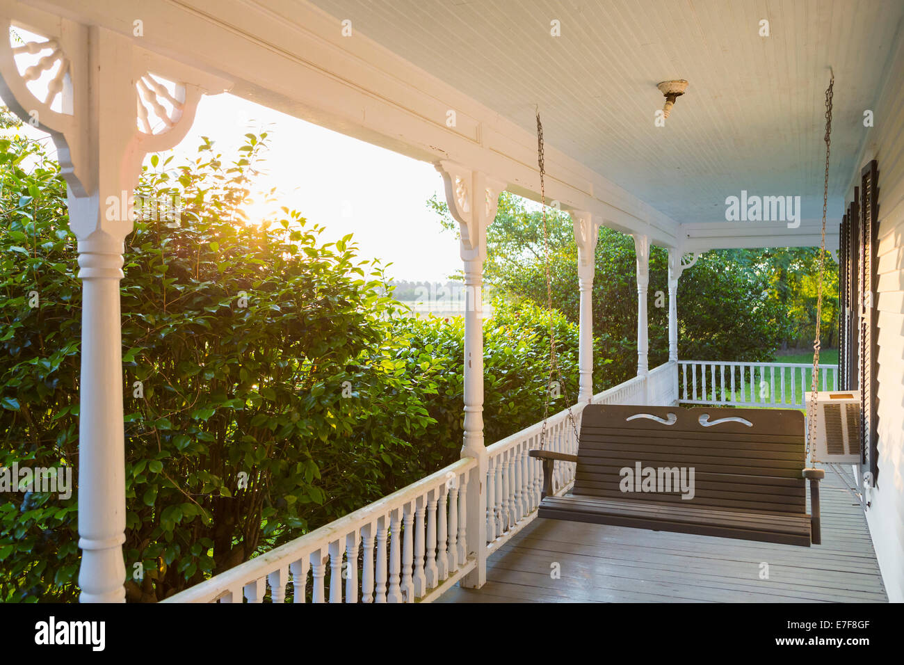 Swing on porch of traditional house Stock Photo